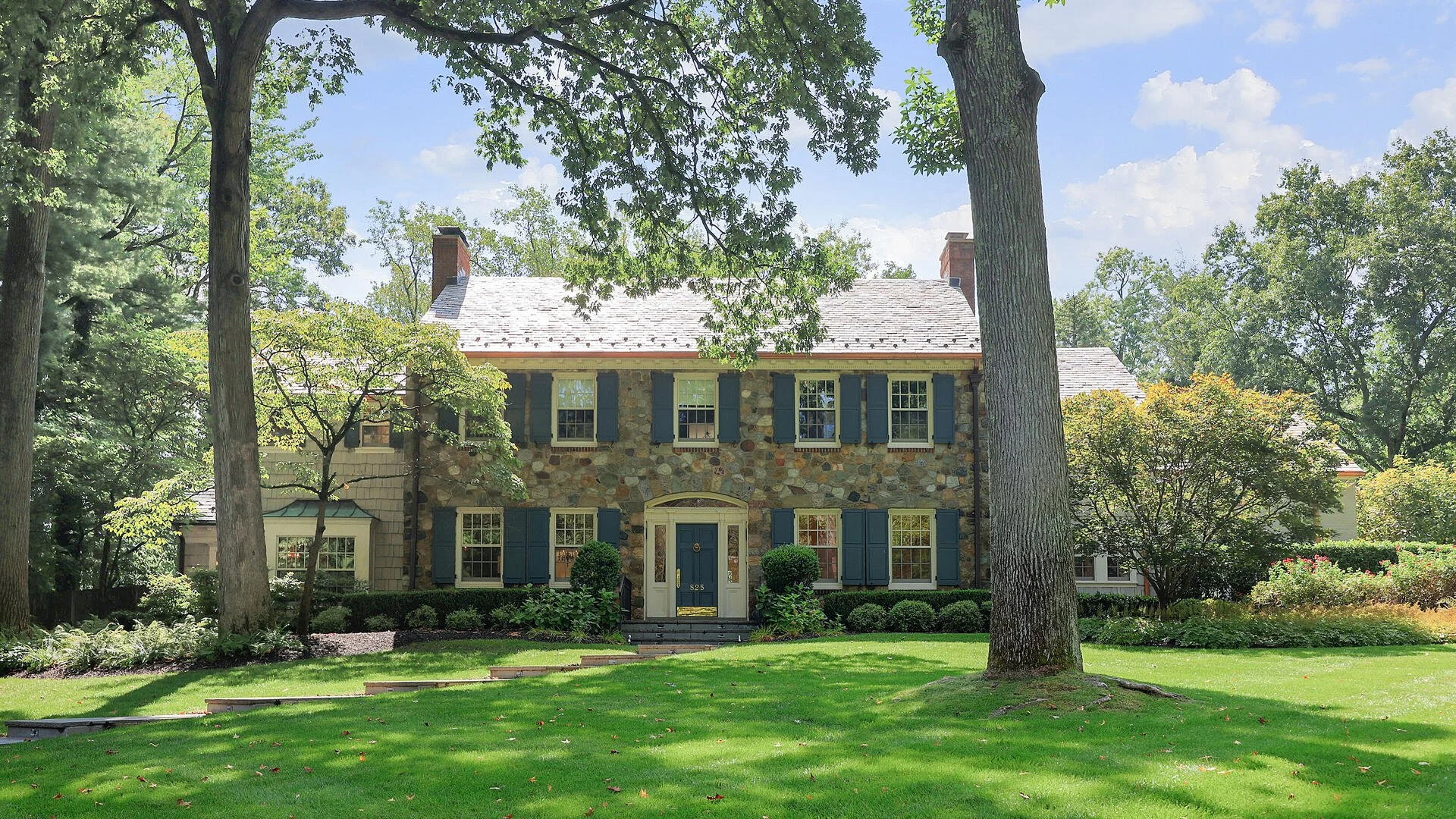 A gracious stone home surrounded by mature trees in Westfield, New Jersey